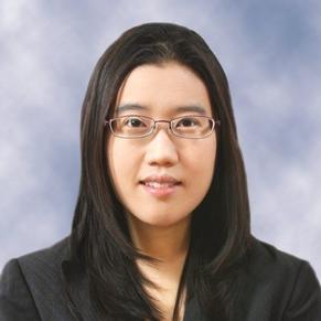 Schar School associate professor Mirae Kim in glasses smiles at the camera.