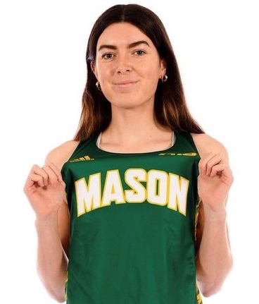 A dark-haired woman in a green tank top shows off her Mason lettering.