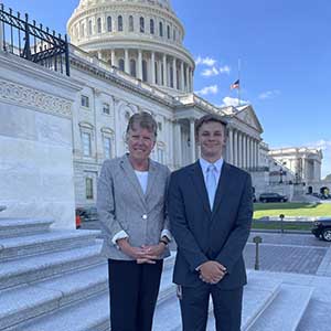 Matthew Glaubke (right) stands with Congresswoman Julia Brownley (D-CA) (left) in front of the U.S. Capitol in Washington, D.C.