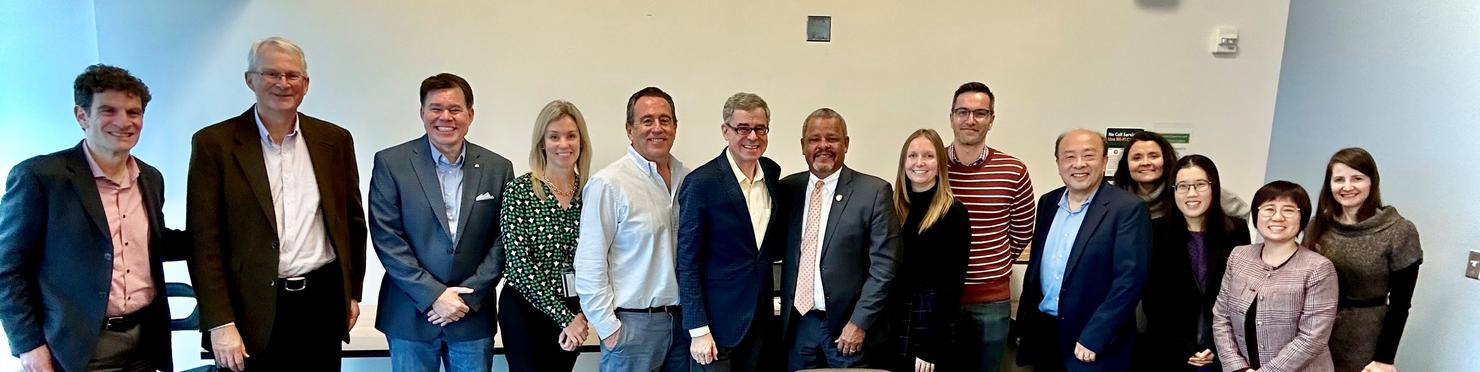 A long line of people smile at the camera.