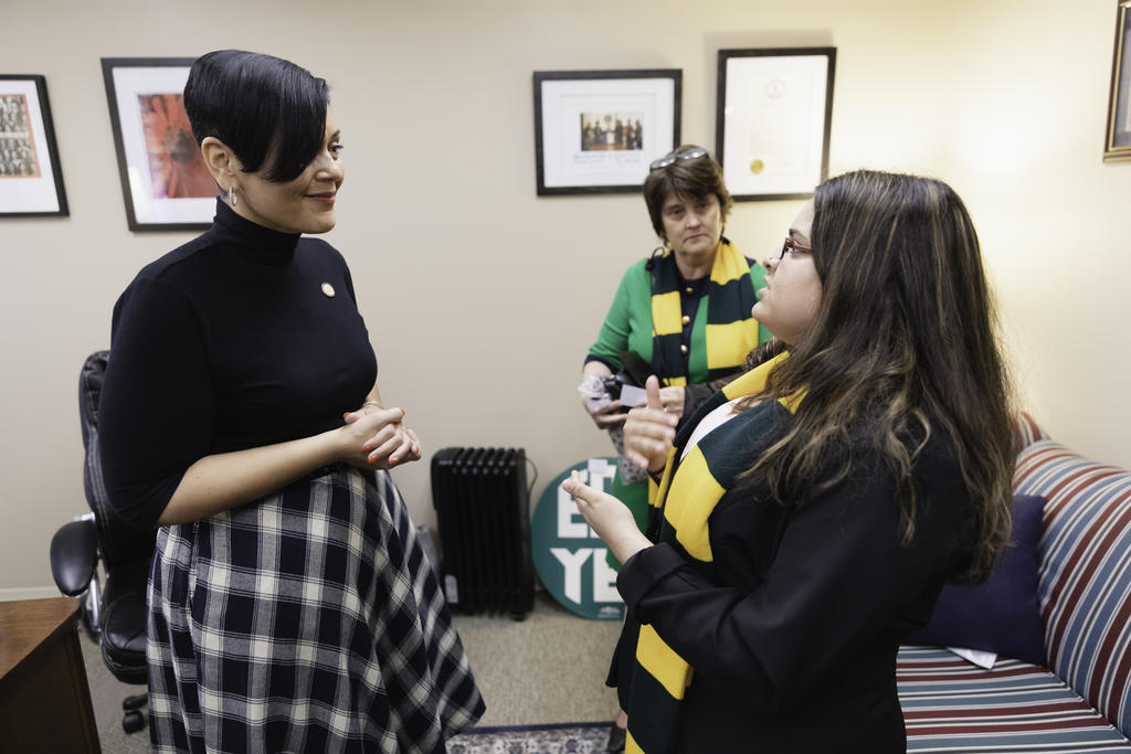 George Mason University student speaking to a woman during a Mason Lobbies Day event